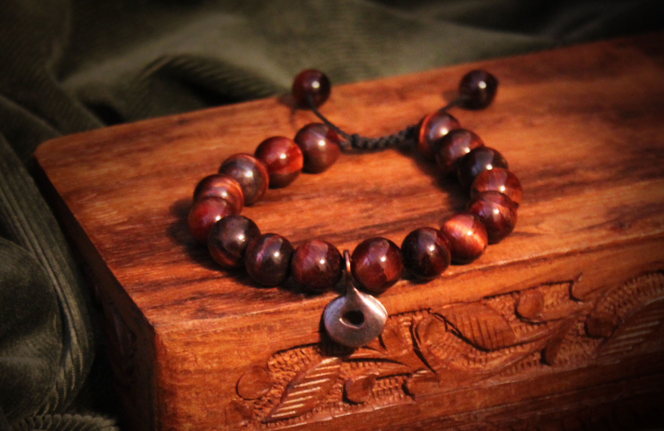 Red Tiger's Eye bracelet on a hand-carved wooden box